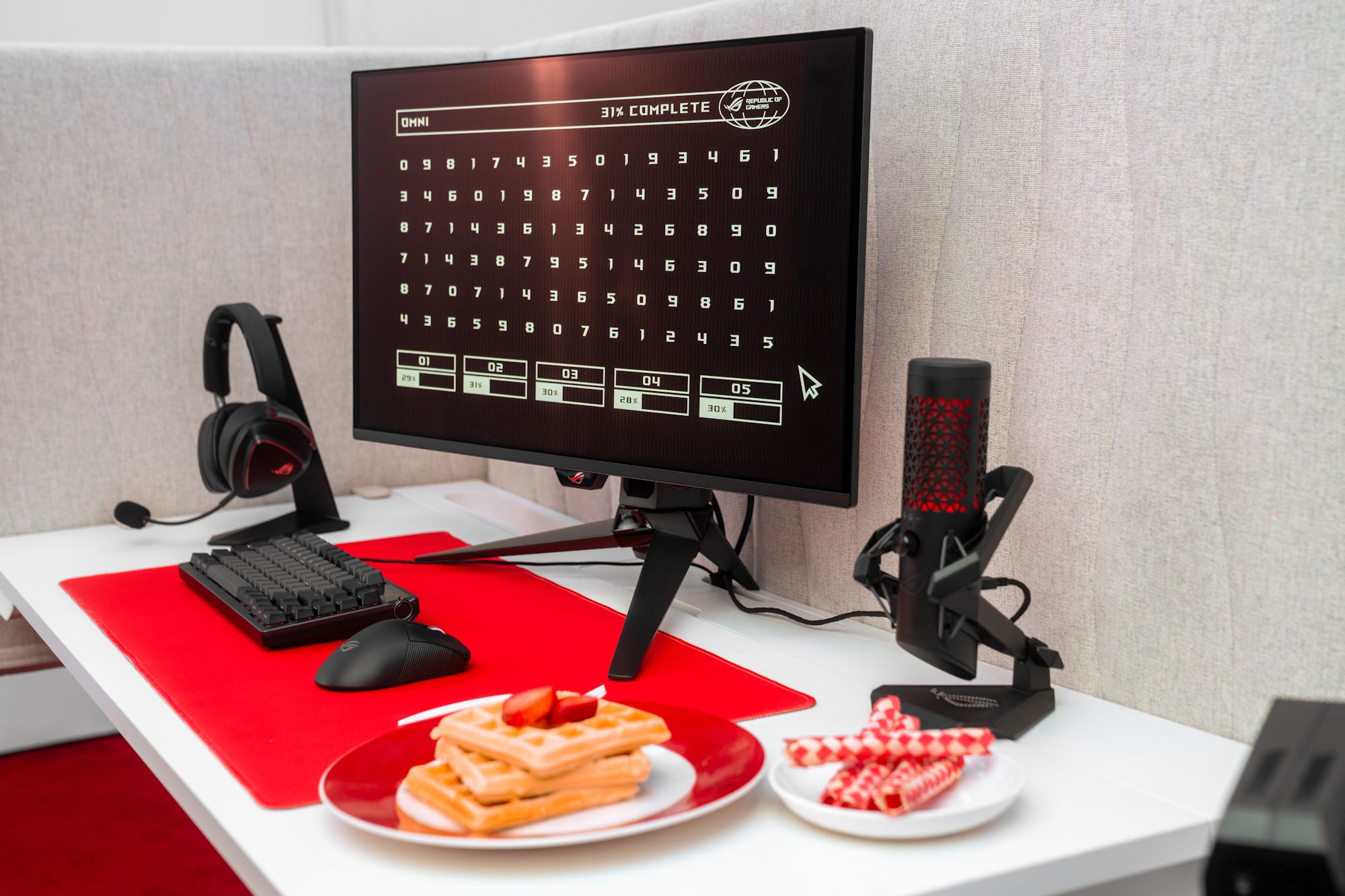 Một trạm máy tính có thiết bị ROG, với hai tấm ở phía trước, một chiếc có bánh quế và một với fingtraps